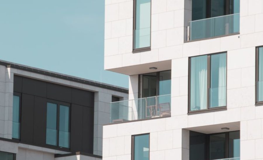 Contemporary apartment buildings in Berlin with elegant white facades and glass balconies.