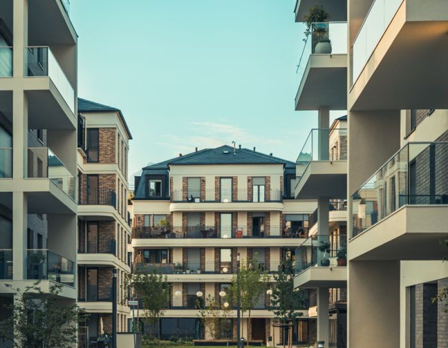 Contemporary cityscape featuring luxury apartments with balconies and outdoor pathways.
